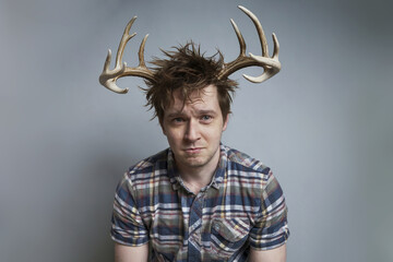 Man with horns on his head, deceived by his wife.