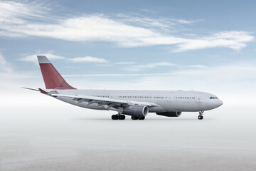 Wide body passenger aircraft isolated on bright background with sky