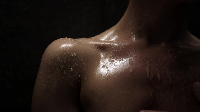 Close-up shot of an attractive woman's collarbone area, with water droplets glistening on her skin. This image conveys a sense of freshness and well-being, perfect for beauty and skincare themes.