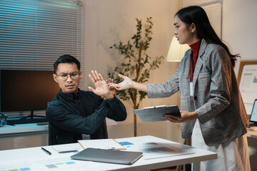 Businessman is refusing more work from his manager while working late in the office