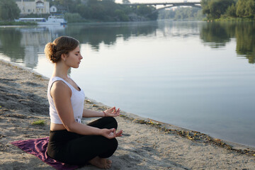 A woman on the beach and meditating