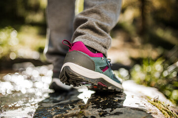 Person wearing hiking shoes on wet rock