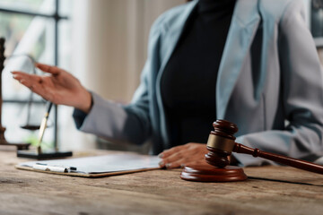 Lawyer is explaining a contract to her client during a meeting in her law office