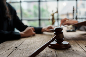 Lawyers are negotiating a contract and using a gavel to finalize the agreement in the courtroom