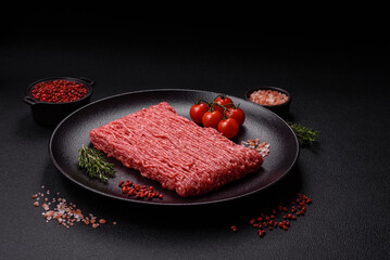 Fresh raw ground beef with salt, spices and herbs