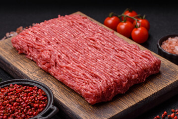 Fresh raw ground beef with salt, spices and herbs