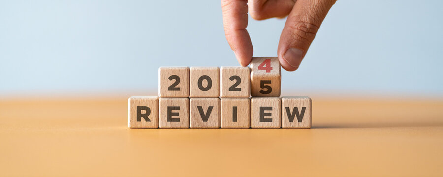 Hand flipping of 2024 to 2025 on wooden blocks. 2024 business and customer review for business strategic planning in the next year 2025. End of the year business concept..