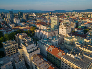 Ljubljana city center skyline aerial view at sunset. Urban area with historic Neboticnik skyscraper towards business district on Dunajska road with skyscrapers of modern architecture in capital city.