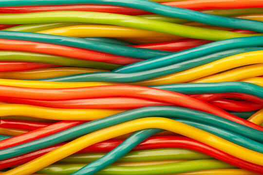 Long chewy marmalade candies of different colors sprinkled with sugar.