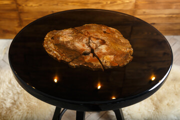 A stylish round table showcasing a stunning petrified wood top