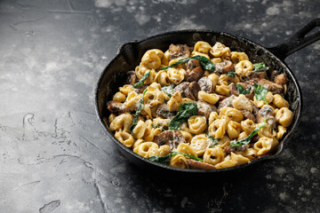 Chestnut Mushrooms and spinach tortellini served with parmesan cheese