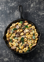 Chestnut Mushrooms and spinach tortellini served with parmesan cheese