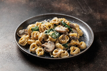 Chestnut Mushrooms and spinach tortellini served with parmesan cheese