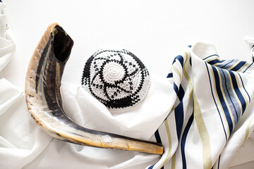 Rosh Hashanah, Sukkot, Yom Kippur concept. Tallit and shofar on white. Traditional holiday symbol.