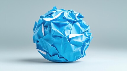 A photostock of a crumpled paper ball on a light background, symbolizing discarded ideas or creativity.