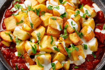 Patatas bravas, spanish deep fried potatoes with spicy sauce and garlic aioli