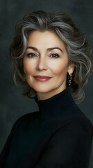 Fototapeta premium Elegant woman with long blonde hair wearing a black turtleneck and blazer, studio portrait with dark background