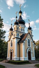 Fototapeta premium Beautiful Orthodox church with golden domes and crosses against a blue sky