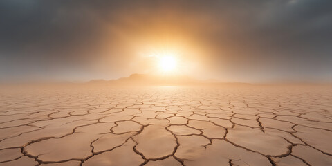 Desolate landscape with cracked earth under a dramatic sunset in a dry region