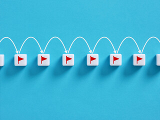 Reaching milestones: white blocks with red flags and arrows symbolizing progress on blue background