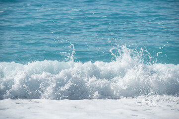 Sunny wave with sea foam and splashes