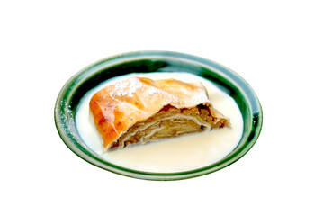Typical Bavarian dessert apple strudel with vanilla cream, isolated