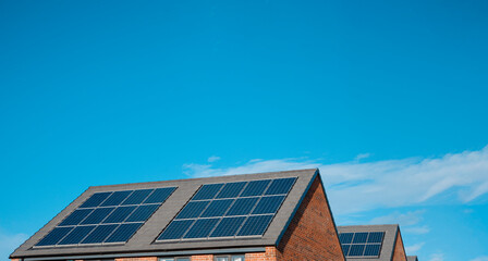 Solar panels glisten under the bright blue sky on modern rooftops in a sustainable community setting