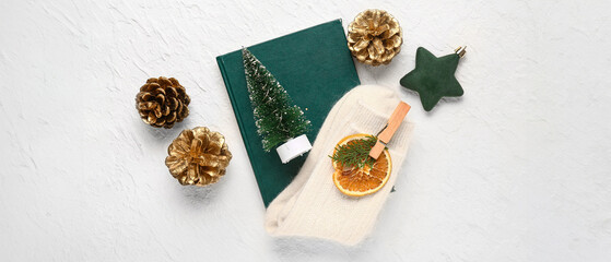 Beautiful composition with warm socks and Christmas decor on white background