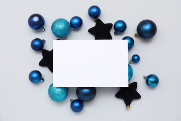 Blank card and Christmas balls on white background