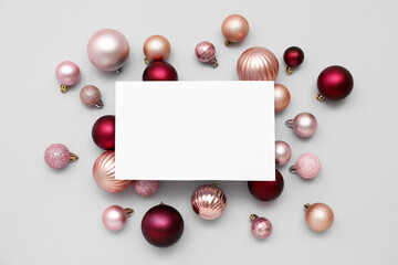 Blank card and Christmas balls on white background
