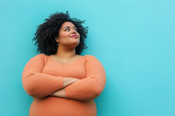 Woman with arms crossed, looking up.