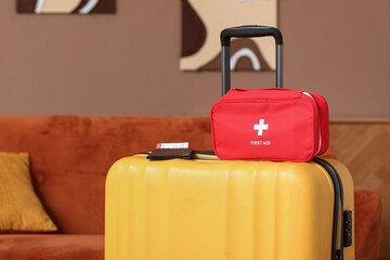 Suitcase with first aid kit and passport in room