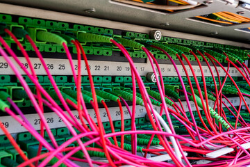 Lot of red optic fiber cables connected to rack router