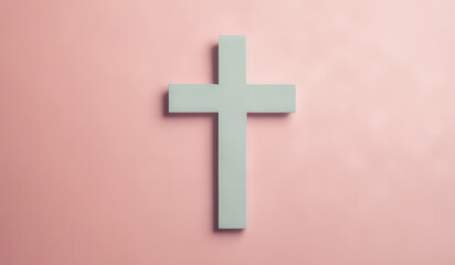 Christian cross on a pastel colored paper textured background with copy space
