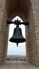 Fototapeta premium Large church bell hanging in the tower with a view over the landscape