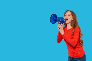 Cheerful young woman enthusiastically speaks into a blue megaphone against a vibrant turquoise...