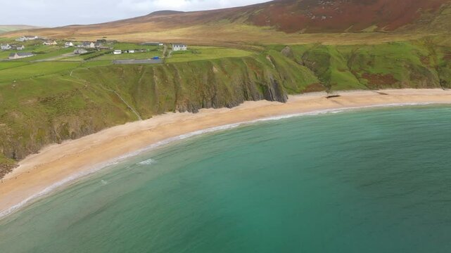 Malin Beg at the west coast of Ireland in Donegal - A breathtakingly stunning view of a rugged coastline featuring rocky cliffs and serene ocean waves softly rolling