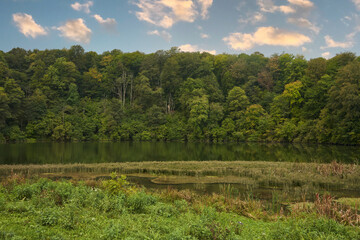 A picturesque lake with aquatic vegetation in the mountains. Upper lake of the Blue Lakes. Natural background.