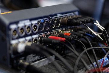 Audio equipment connections at a live music venue showcasing various cables and interfaces during a...