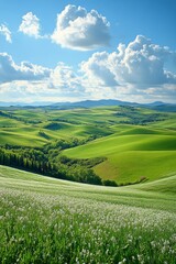 Lush green rolling hills under a partially cloudy sky in a serene landscape during midday
