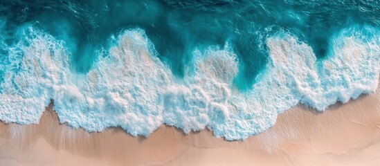 Aerial View of Ocean Waves Crashing on Sandy Shore