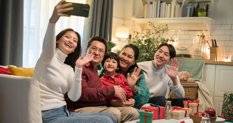 Asian big family taking selfie together at home