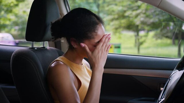 African American woman driver crying worry stressed road accident depression sitting car auto automobile transport female businesswoman business despair close face hands frustrated girl problems lost