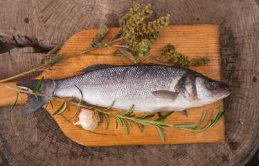 Raw sea bass fish on wooden table
