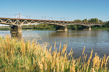 Fototapeta premium Swietokrzyski bridge over the Vistula river in Warsaw, Poland in a bright sunny day