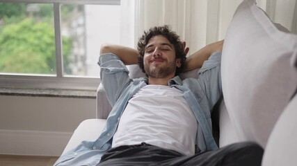 Happy lazy young man relax daydream meditate sit on comfortable sofa at home in living room, calm guy rest breathing fresh air having nap with eyes closed feel peace of mind, no stress free relief
 - Powered by Adobe