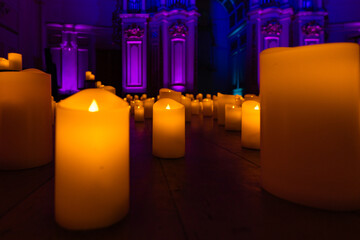blurred symphonic orchestra on stage with lots of candles