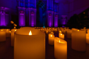 blurred symphonic orchestra on stage with lots of candles