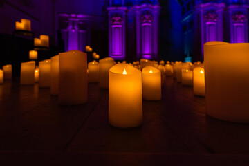 blurred symphonic orchestra on stage with lots of candles