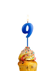 Candle in shape of the number 9 - Blue birthday on a white background.